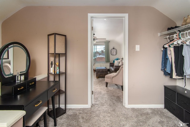 spacious closet with ceiling fan, carpet, and lofted ceiling