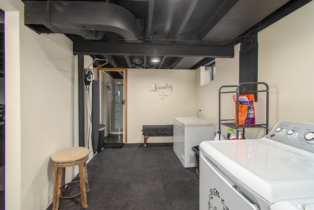 laundry room featuring laundry area, washer / dryer, and dark carpet