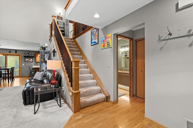 stairway featuring baseboards and wood finished floors