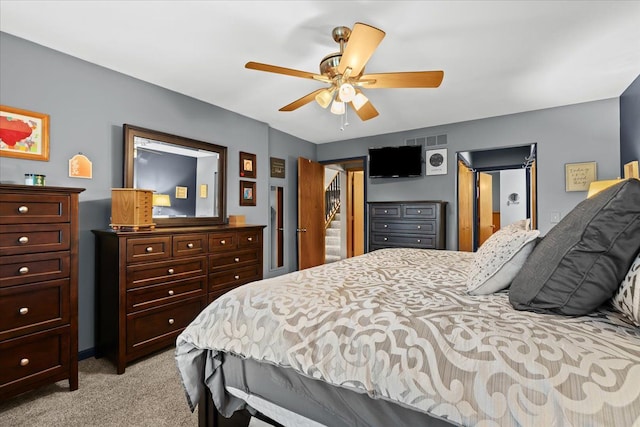 bedroom featuring light colored carpet, a ceiling fan, and visible vents