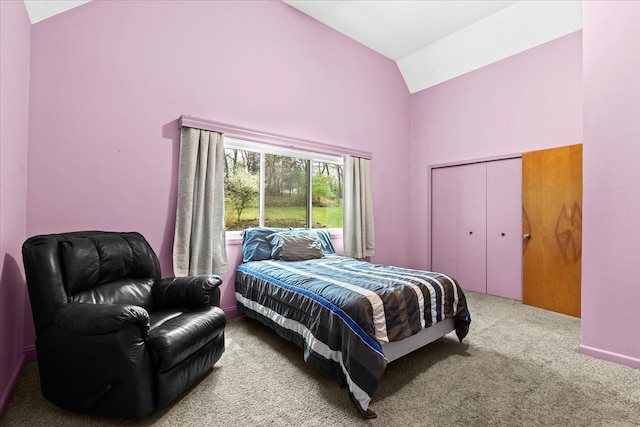 bedroom featuring carpet floors, a closet, and high vaulted ceiling