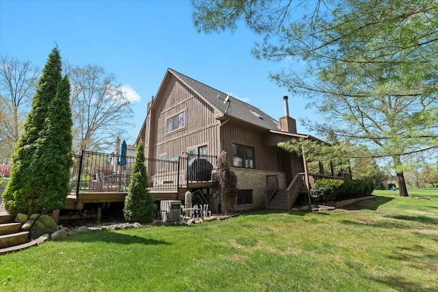 rear view of property featuring stairs, a lawn, a wooden deck, and cooling unit