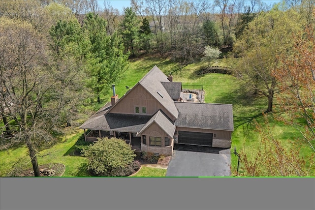 drone / aerial view featuring a wooded view