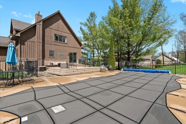 view of swimming pool featuring fence, a patio, and central AC unit