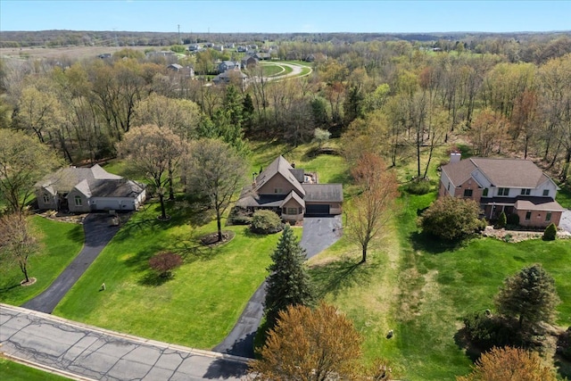 birds eye view of property featuring a wooded view