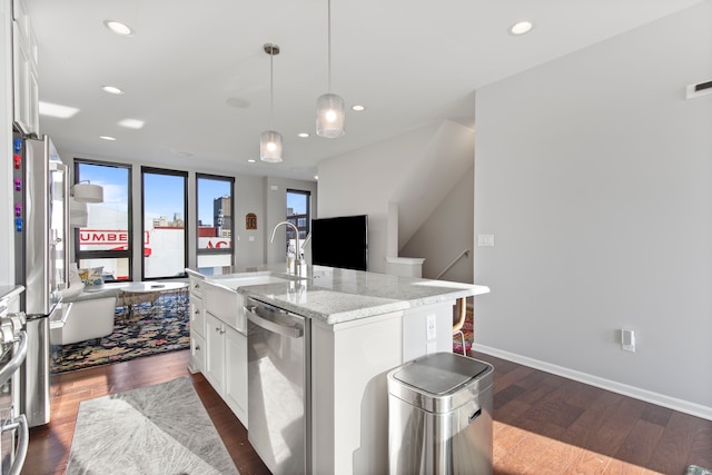 kitchen with dark wood-style flooring, appliances with stainless steel finishes, a sink, white cabinetry, and recessed lighting