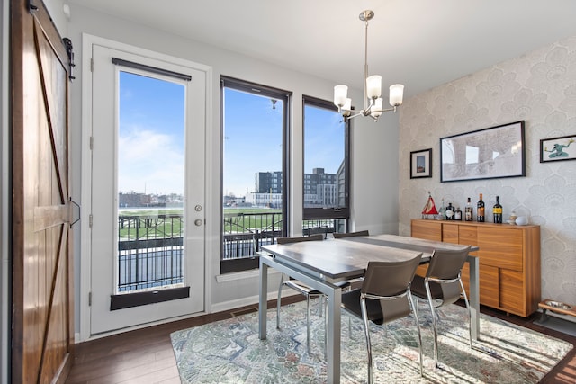 dining space with a view of city, wallpapered walls, a notable chandelier, and a wealth of natural light