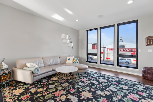 living room featuring recessed lighting, baseboards, and wood finished floors