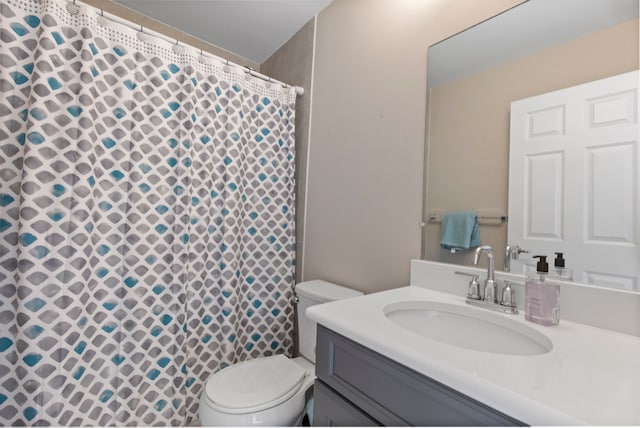 bathroom featuring toilet, a shower with curtain, and vanity