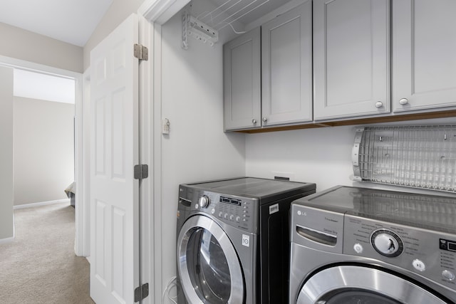 washroom featuring carpet, baseboards, cabinet space, and independent washer and dryer
