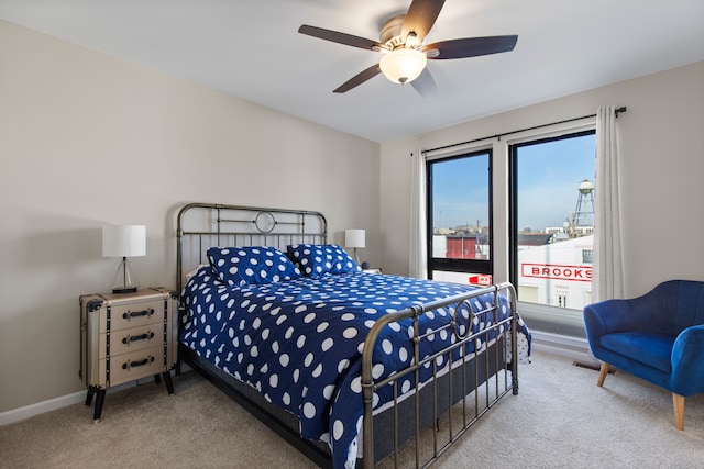 carpeted bedroom with baseboards and a ceiling fan