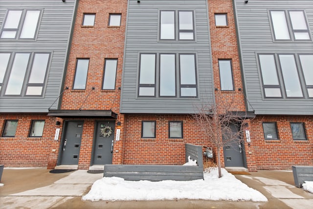 townhome / multi-family property featuring brick siding