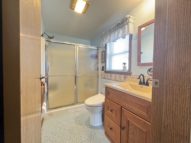 full bathroom featuring toilet, a shower stall, tile patterned flooring, and vanity