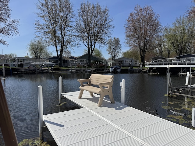view of dock with a residential view and a water view