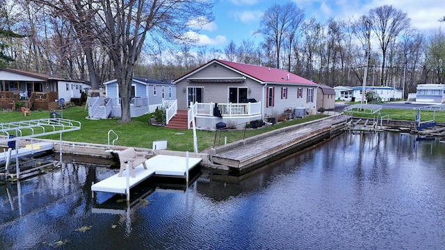 dock area with a yard and a deck with water view