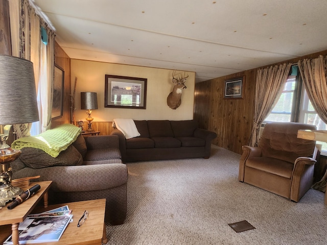 1837 9 Mile Rd, Sears, MI 49679 - carpeted living room with wood walls