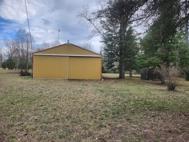 1837 9 Mile Rd, Sears, MI 49679 - view of green lawn featuring a pole building, an outbuilding, and a detached garage