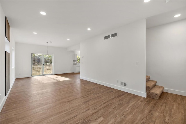 494 Bloomfield Ave, Pontiac, MI 48341 - unfurnished living room featuring baseboards, recessed lighting, wood finished floors, and visible vents