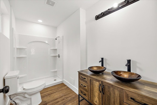 494 Bloomfield Ave, Pontiac, MI 48341 - full bathroom with visible vents, walk in shower, wood finished floors, a sink, and toilet