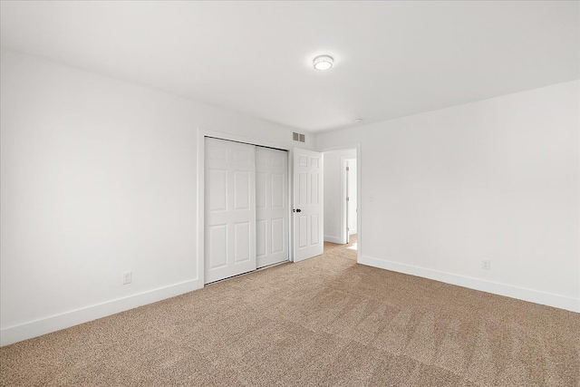 494 Bloomfield Ave, Pontiac, MI 48341 - unfurnished bedroom with baseboards, visible vents, light carpet, and a closet