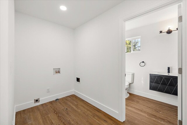 494 Bloomfield Ave, Pontiac, MI 48341 - washroom featuring electric dryer hookup, baseboards, wood finished floors, and washer hookup