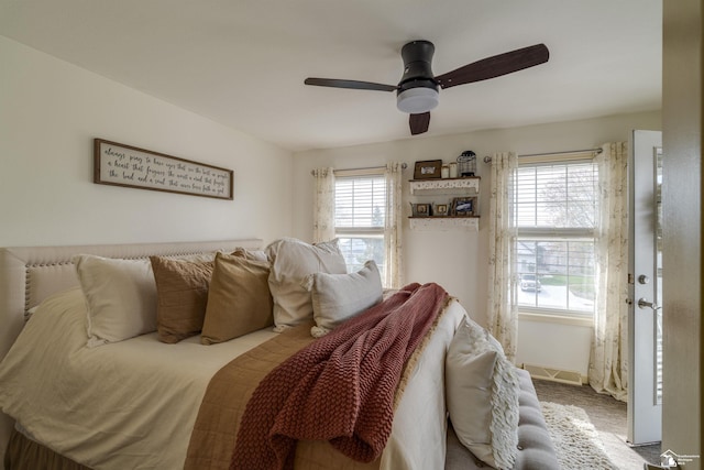 carpeted bedroom featuring ceiling fan and visible vents