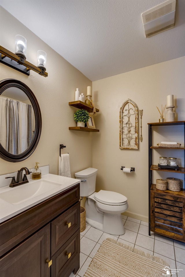 bathroom featuring a textured ceiling, visible vents, tile patterned floors, vanity, and toilet