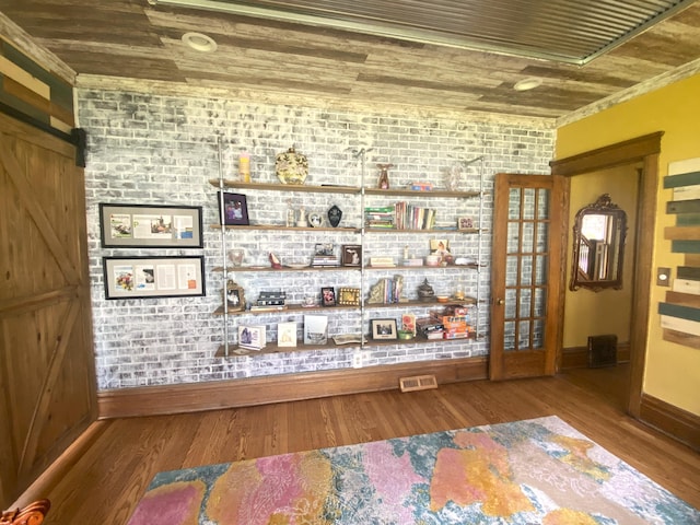 room details featuring baseboards, a barn door, wood ceiling, and wood finished floors