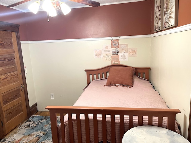 bedroom with ceiling fan and wood finished floors