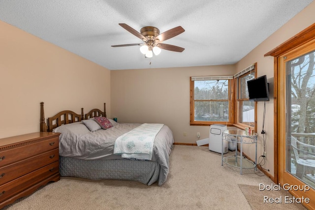 bedroom with baseboards, carpet, a ceiling fan, and a textured ceiling