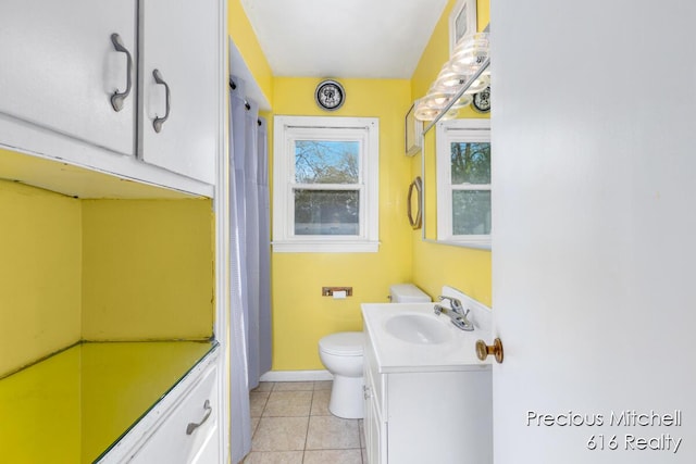 full bath with vanity, baseboards, tile patterned floors, and toilet