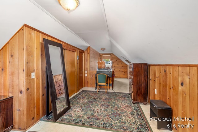bonus room with wood walls and lofted ceiling