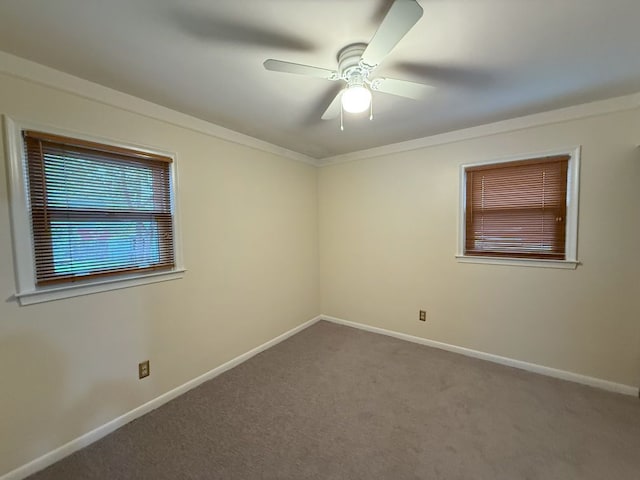 empty room with baseboards, ornamental molding, a ceiling fan, and carpet floors