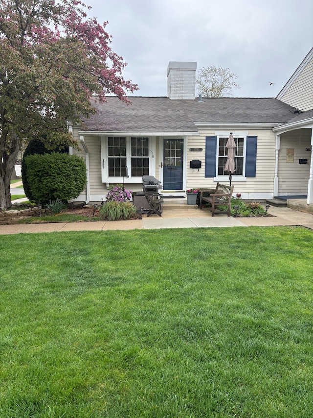 41781 Onaway Dr, Northville, MI 48167 - single story home featuring a chimney, roof with shingles, and a front yard