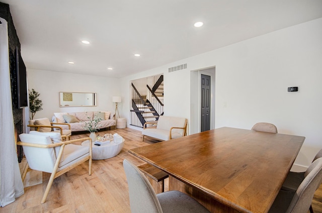 dining room featuring recessed lighting, visible vents, light wood finished floors, and stairway