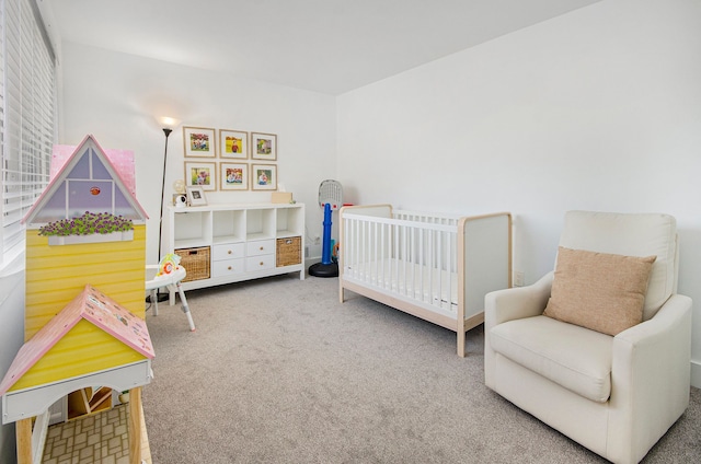 bedroom with a crib and carpet