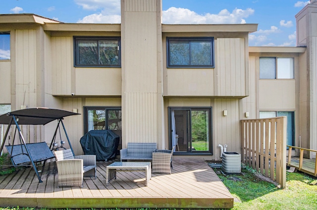 back of property with central air condition unit and a wooden deck