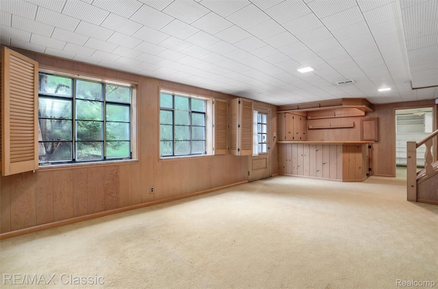 830 Jonathan Ln, Bloomfield Hills, MI 48302 - unfurnished living room featuring wooden walls and carpet