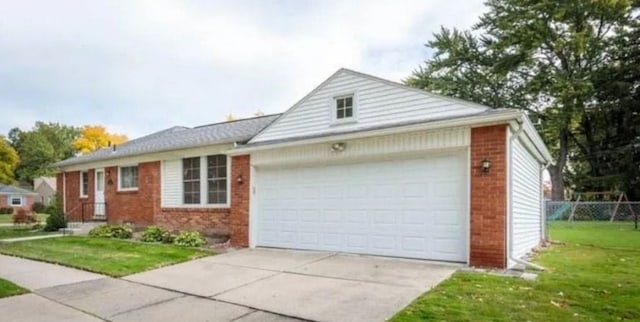 single story home featuring a garage, concrete driveway, a front yard, and brick siding