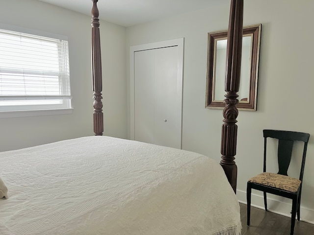bedroom featuring baseboards, a closet, and wood finished floors
