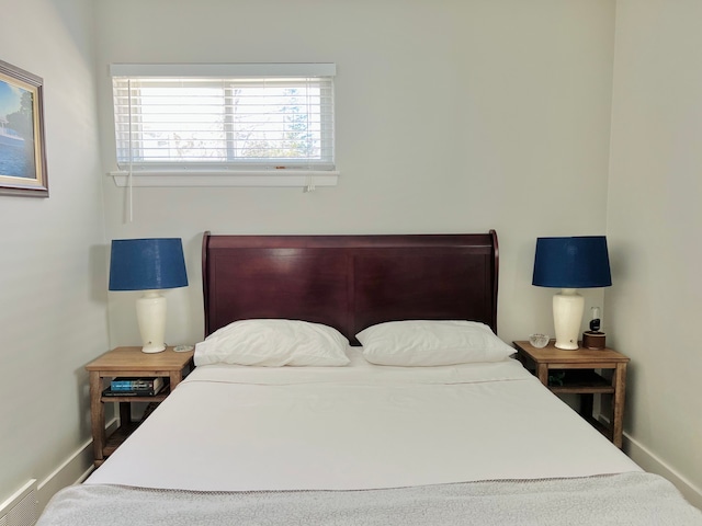 bedroom with baseboards and visible vents