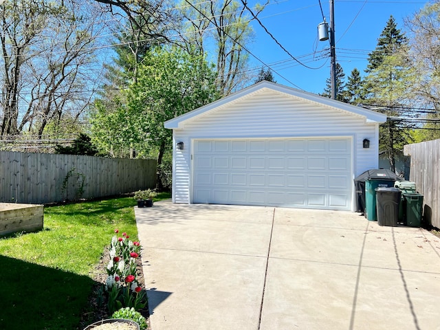 detached garage featuring fence