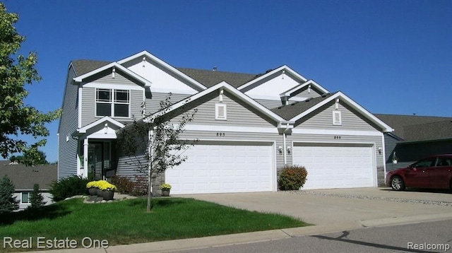 craftsman inspired home with driveway and a garage