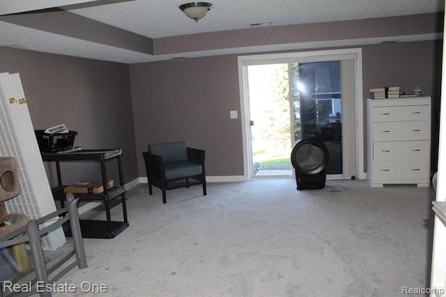 sitting room with light colored carpet and baseboards