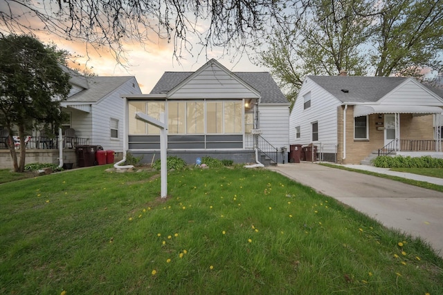 view of front of home with a yard and entry steps