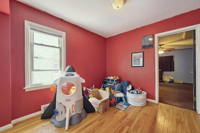 game room featuring baseboards and hardwood / wood-style flooring