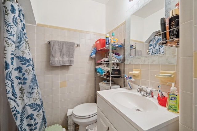 full bath with vanity, curtained shower, toilet, and tile walls