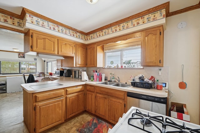 kitchen with a peninsula, a sink, dishwashing machine, and tasteful backsplash