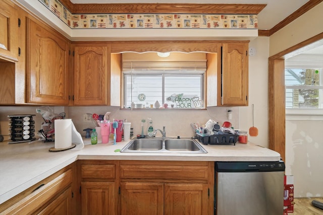 kitchen with crown molding, a sink, dishwasher, light countertops, and brown cabinetry