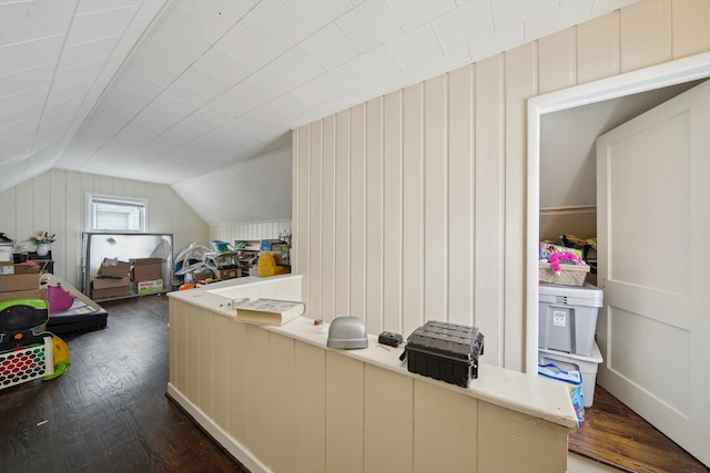 interior space with vaulted ceiling and dark wood-style floors